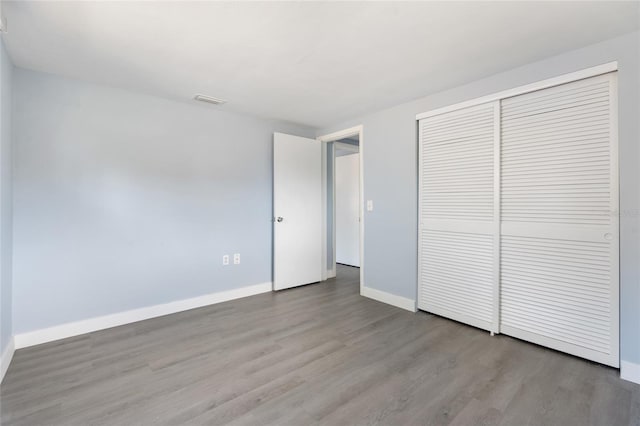 5027 Overton Dr, New Port Richey, FL 34652 - unfurnished bedroom featuring wood finished floors and a closet