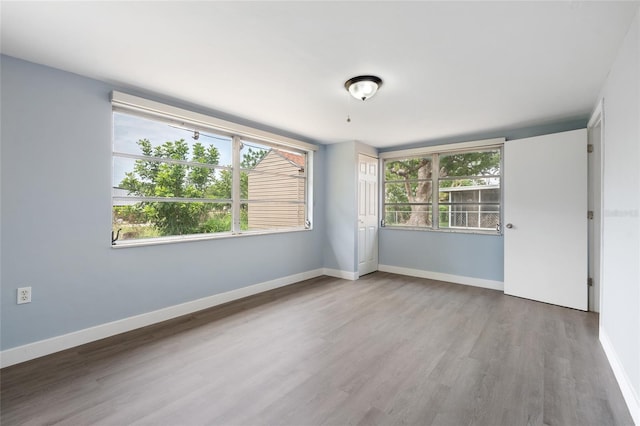5027 Overton Dr, New Port Richey, FL 34652 - empty room with wood finished floors and baseboards