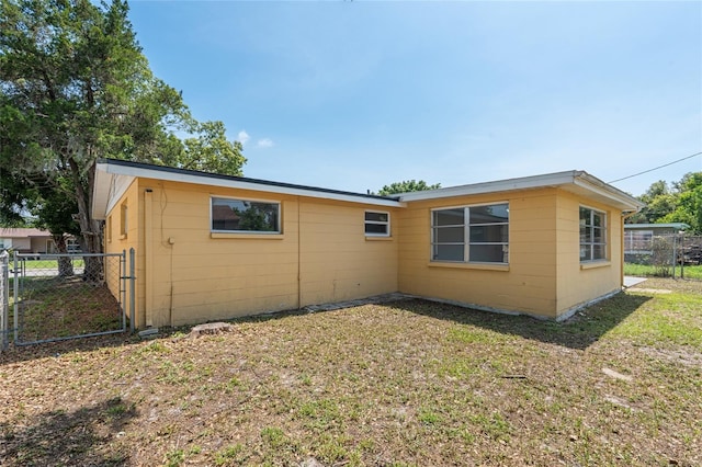 5027 Overton Dr, New Port Richey, FL 34652 - view of side of property with a gate