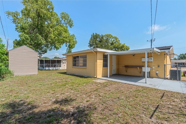 5027 Overton Dr, New Port Richey, FL 34652 - rear view of property with a sunroom