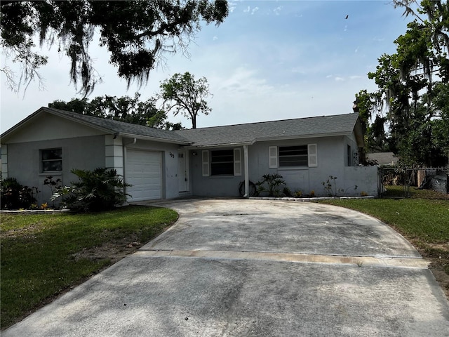 103 Inwood Cir, Brandon, FL 33510 - ranch-style home with stucco siding, an attached garage, and concrete driveway