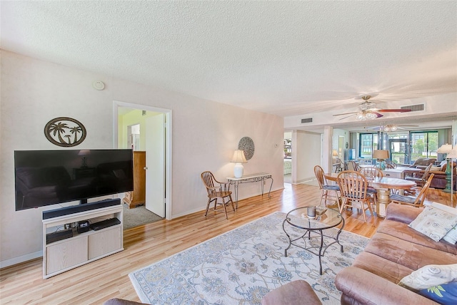 14130 Rosemary Ln Unit 4115, Largo, FL 33774 - living area with a textured ceiling, wood finished floors, ceiling fan, and baseboards