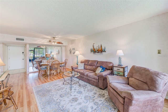 14130 Rosemary Ln Unit 4115, Largo, FL 33774 - living area with light wood-style floors, a textured ceiling, and a ceiling fan
