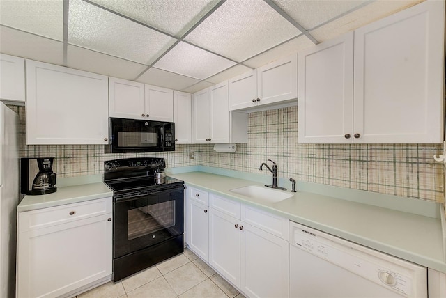 14130 Rosemary Ln Unit 4115, Largo, FL 33774 - kitchen featuring black appliances, a sink, light countertops, white cabinets, and light tile patterned flooring