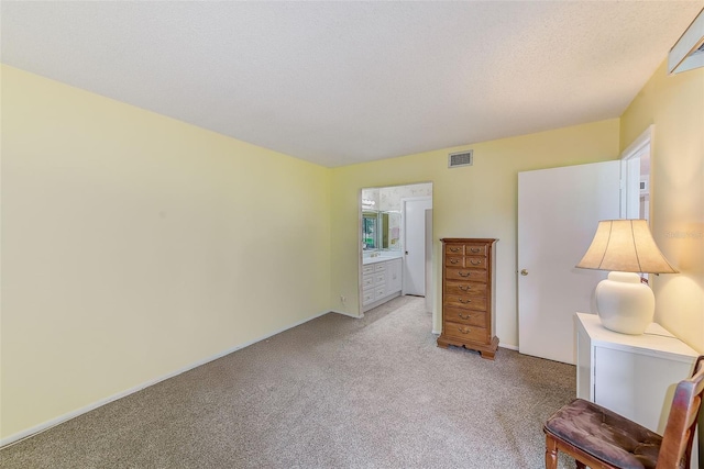 14130 Rosemary Ln Unit 4115, Largo, FL 33774 - bedroom with light colored carpet, baseboards, and ensuite bathroom