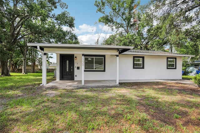 2220 3rd Ave E, Bradenton, FL 34208 - view of front of house with covered porch, a front lawn, and stucco siding
