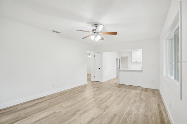 2220 3rd Ave E, Bradenton, FL 34208 - unfurnished living room featuring ceiling fan, light wood-style flooring, and baseboards