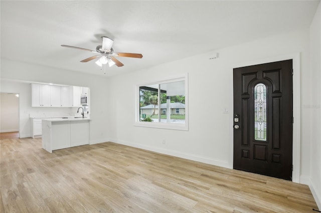2220 3rd Ave E, Bradenton, FL 34208 - foyer entrance with light wood finished floors, baseboards, and ceiling fan