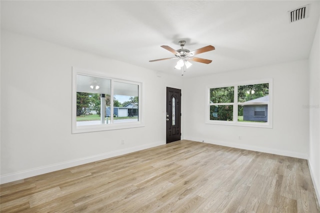 2220 3rd Ave E, Bradenton, FL 34208 - spare room with healthy amount of natural light, light wood-style flooring, ceiling fan, and baseboards