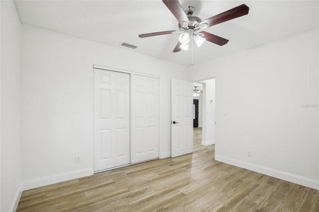 2220 3rd Ave E, Bradenton, FL 34208 - unfurnished bedroom with light wood-style flooring, baseboards, a closet, and ceiling fan