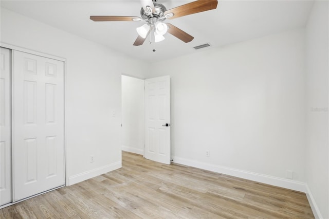 2220 3rd Ave E, Bradenton, FL 34208 - unfurnished bedroom with light wood-style flooring, baseboards, a closet, and a ceiling fan