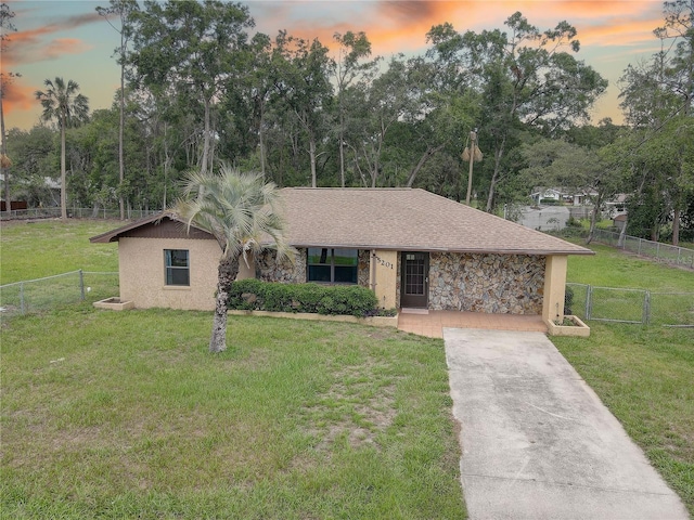 5201 E Jasmine Ln, Inverness, FL 34453 - view of front of property featuring a gate, concrete driveway, stucco siding, and view of scattered trees