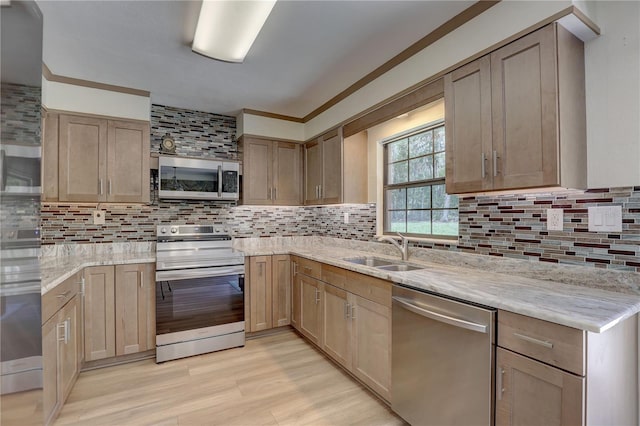 5201 E Jasmine Ln, Inverness, FL 34453 - kitchen with stainless steel appliances, a sink, tasteful backsplash, light stone countertops, and light wood-style flooring