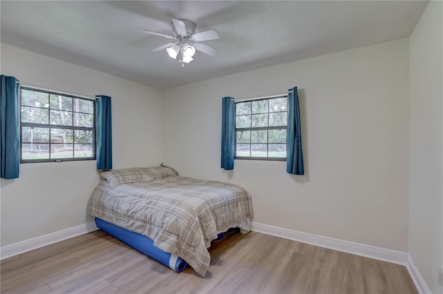 5201 E Jasmine Ln, Inverness, FL 34453 - bedroom featuring wood finished floors, baseboards, and ceiling fan