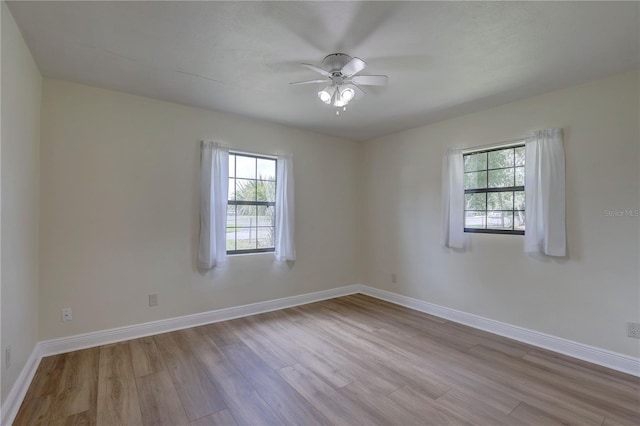 5201 E Jasmine Ln, Inverness, FL 34453 - empty room with wood finished floors, a ceiling fan, and baseboards