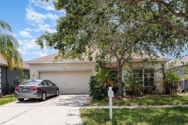 7603 Wood Violet Dr, Gibsonton, FL 33534 - view of front of property with concrete driveway, an attached garage, and stucco siding