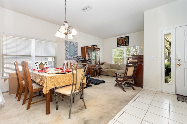 7603 Wood Violet Dr, Gibsonton, FL 33534 - dining area featuring a chandelier, light colored carpet, baseboards, lofted ceiling, and light tile patterned flooring