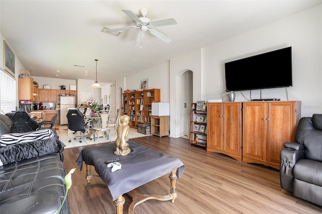 7603 Wood Violet Dr, Gibsonton, FL 33534 - living room featuring arched walkways, light wood finished floors, and ceiling fan