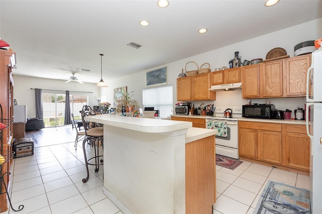 7603 Wood Violet Dr, Gibsonton, FL 33534 - kitchen with white appliances, under cabinet range hood, light countertops, recessed lighting, and light tile patterned floors