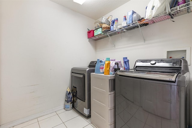 7603 Wood Violet Dr, Gibsonton, FL 33534 - laundry area with separate washer and dryer, light tile patterned flooring, and baseboards