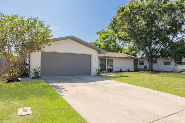 11296 115th St, Largo, FL 33778 - ranch-style house with an attached garage, concrete driveway, and a front yard