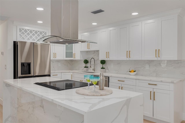 11296 115th St, Largo, FL 33778 - kitchen featuring stainless steel fridge, island range hood, white cabinetry, a kitchen island, and a sink