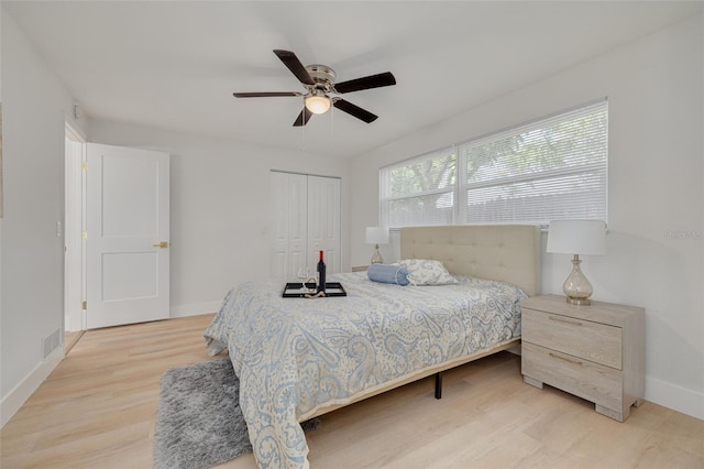 11296 115th St, Largo, FL 33778 - bedroom with light wood finished floors, a closet, baseboards, and ceiling fan