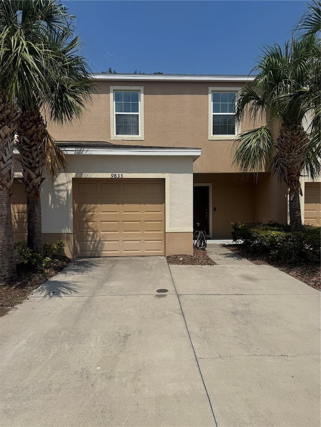 9833 Hound Chase Dr, Gibsonton, FL 33534 - view of front of property featuring stucco siding, a garage, and concrete driveway