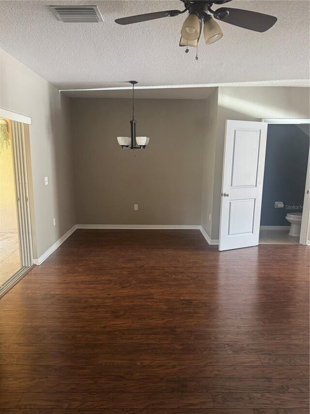9833 Hound Chase Dr, Gibsonton, FL 33534 - empty room featuring ceiling fan, dark wood-type flooring, a textured ceiling, and baseboards