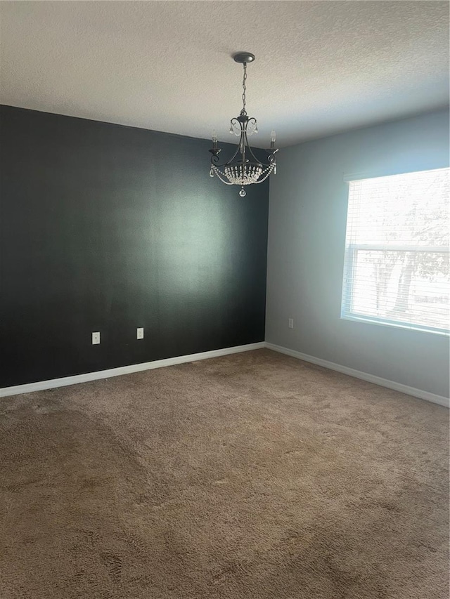 9833 Hound Chase Dr, Gibsonton, FL 33534 - carpeted spare room with a chandelier, a textured ceiling, and baseboards