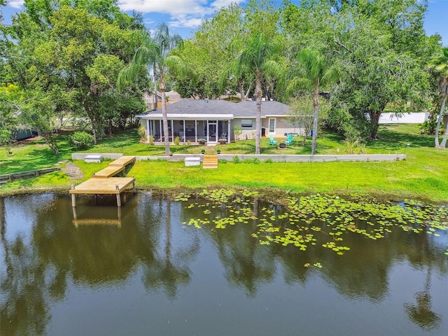 3366 Clover Leaf Ln, Land O Lakes, FL 34639 - rear view of house featuring a water view, a sunroom, and a lawn