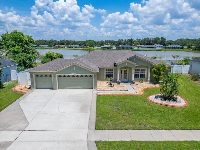 6425 Clair Shore Dr, Apollo Beach, FL 33572 - single story home with an attached garage, concrete driveway, stucco siding, a water view, and a gate