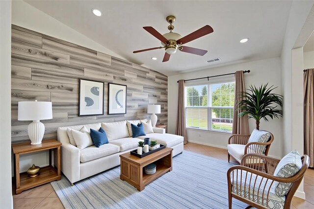 6425 Clair Shore Dr, Apollo Beach, FL 33572 - living area with an accent wall, light tile patterned flooring, a ceiling fan, recessed lighting, and lofted ceiling