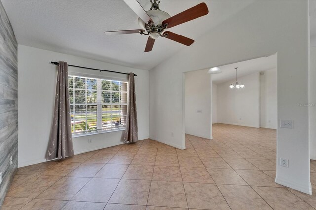 6425 Clair Shore Dr, Apollo Beach, FL 33572 - spare room featuring vaulted ceiling, a chandelier, ceiling fan, light tile patterned floors, and baseboards