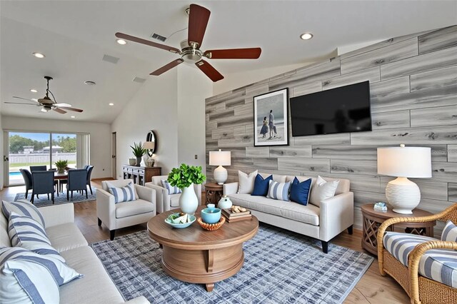 6425 Clair Shore Dr, Apollo Beach, FL 33572 - living area featuring an accent wall, a ceiling fan, recessed lighting, vaulted ceiling, and wood finished floors