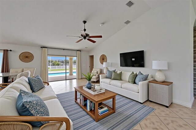 6425 Clair Shore Dr, Apollo Beach, FL 33572 - living area featuring lofted ceiling, light tile patterned floors, a ceiling fan, and baseboards