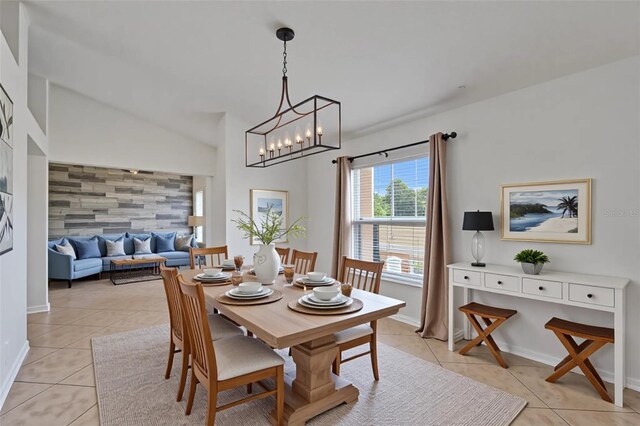 6425 Clair Shore Dr, Apollo Beach, FL 33572 - dining space with light tile patterned floors, baseboards, a chandelier, and lofted ceiling