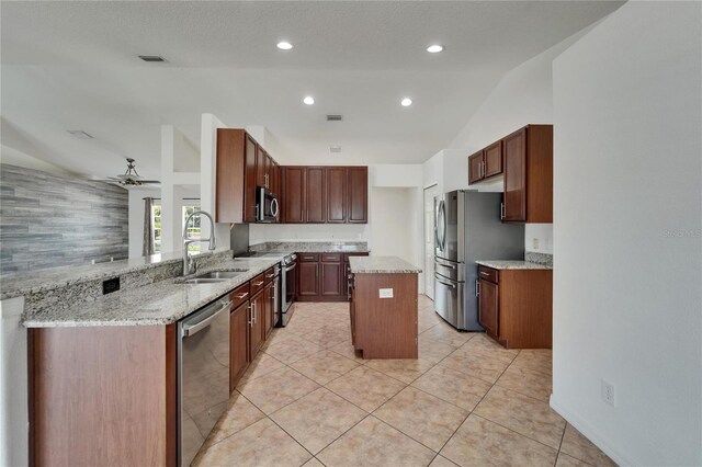 6425 Clair Shore Dr, Apollo Beach, FL 33572 - kitchen featuring appliances with stainless steel finishes, a sink, a ceiling fan, lofted ceiling, and a center island
