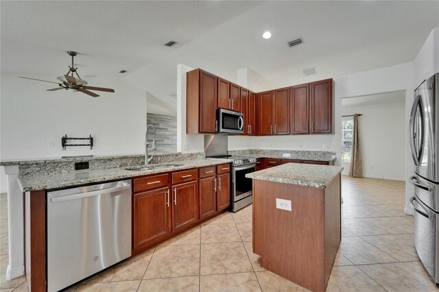 6425 Clair Shore Dr, Apollo Beach, FL 33572 - kitchen with appliances with stainless steel finishes, a sink, lofted ceiling, a peninsula, and ceiling fan
