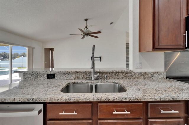 6425 Clair Shore Dr, Apollo Beach, FL 33572 - kitchen featuring a sink, ceiling fan, dishwasher, vaulted ceiling, and light stone countertops