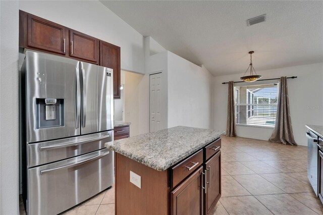 6425 Clair Shore Dr, Apollo Beach, FL 33572 - kitchen with appliances with stainless steel finishes, a kitchen island, light tile patterned floors, decorative light fixtures, and light stone countertops