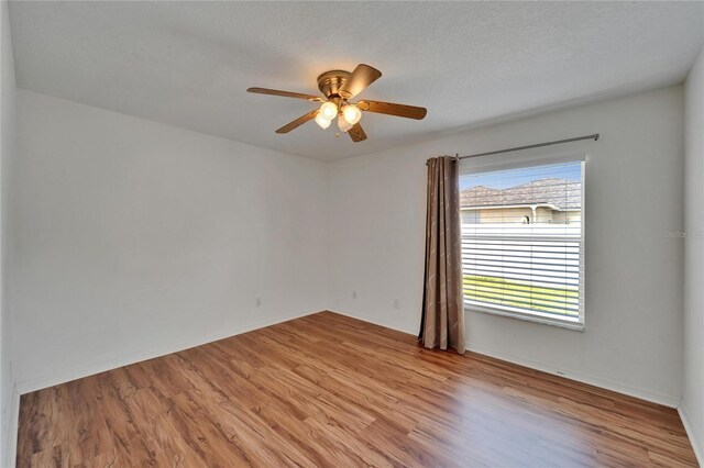 6425 Clair Shore Dr, Apollo Beach, FL 33572 - unfurnished room featuring light wood-type flooring, ceiling fan, and baseboards