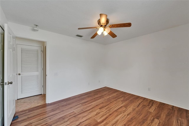 6425 Clair Shore Dr, Apollo Beach, FL 33572 - empty room featuring light wood finished floors, a ceiling fan, and baseboards