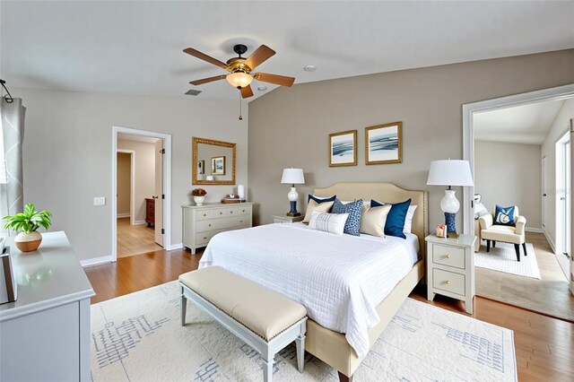 6425 Clair Shore Dr, Apollo Beach, FL 33572 - bedroom with vaulted ceiling, wood finished floors, baseboards, and ceiling fan