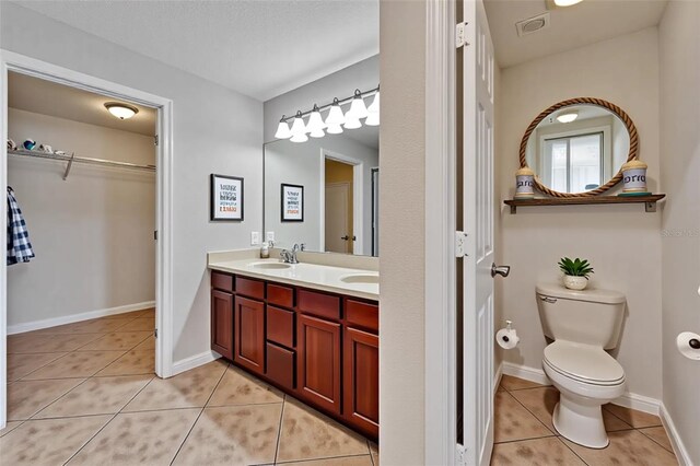 6425 Clair Shore Dr, Apollo Beach, FL 33572 - full bath featuring tile patterned flooring, double vanity, toilet, and a spacious closet