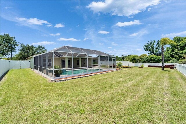 6425 Clair Shore Dr, Apollo Beach, FL 33572 - view of yard featuring an outdoor pool, glass enclosure, and a gate