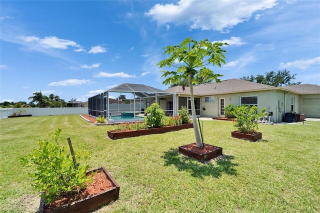 6425 Clair Shore Dr, Apollo Beach, FL 33572 - rear view of house with a garden, stucco siding, and a lanai