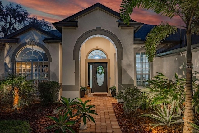 15934 Sorawater Dr, Lithia, FL 33547 - exterior entry at dusk featuring stucco siding