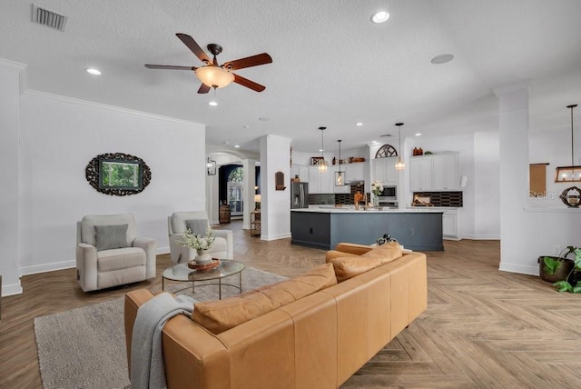 15934 Sorawater Dr, Lithia, FL 33547 - living area with a ceiling fan, baseboards, recessed lighting, arched walkways, and a textured ceiling