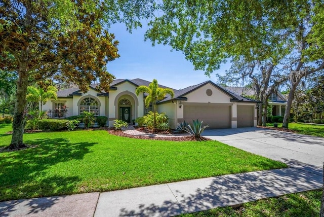 15934 Sorawater Dr, Lithia, FL 33547 - ranch-style house with stucco siding, a garage, and a front lawn